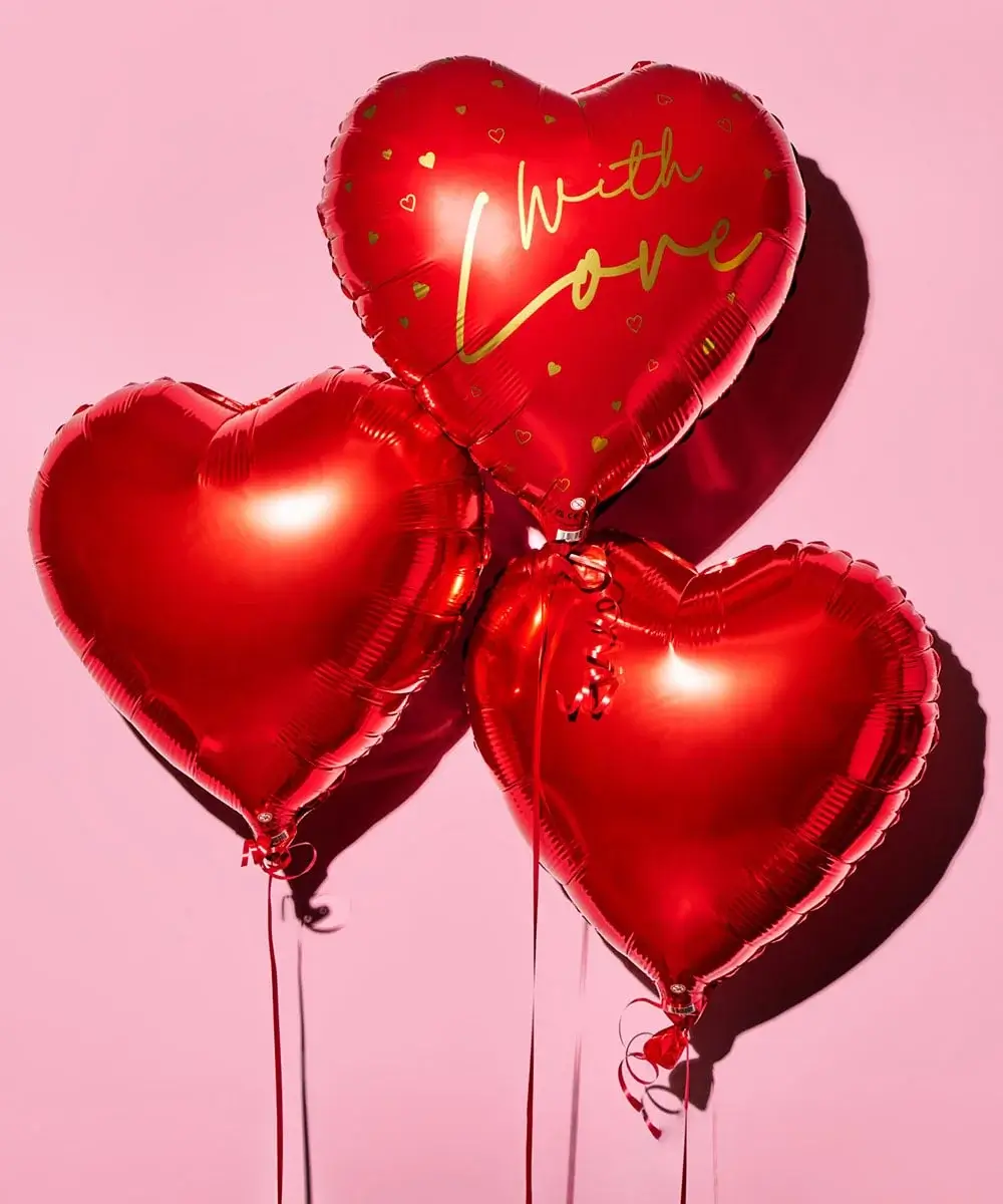 Three shiny red heart-shaped balloons against a pink background, with one balloon featuring the words With Love in gold lettering.